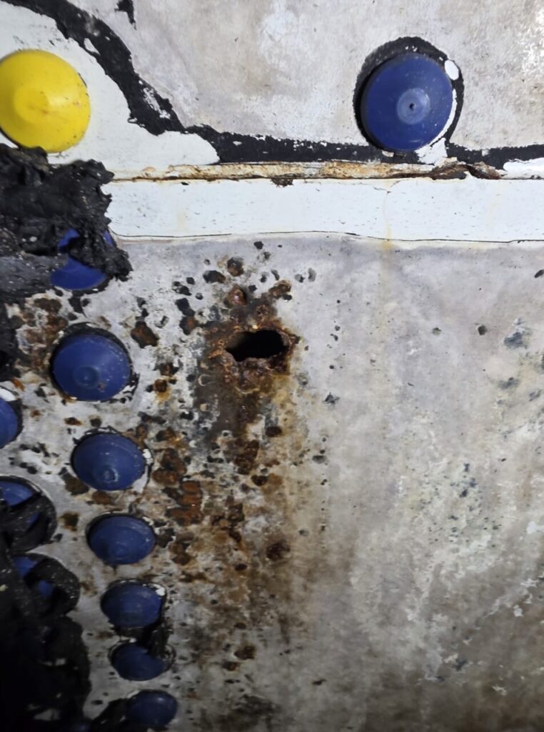 Temporary patch repairs had been attempted previously, but the client required a long-term industrial tank lining solution