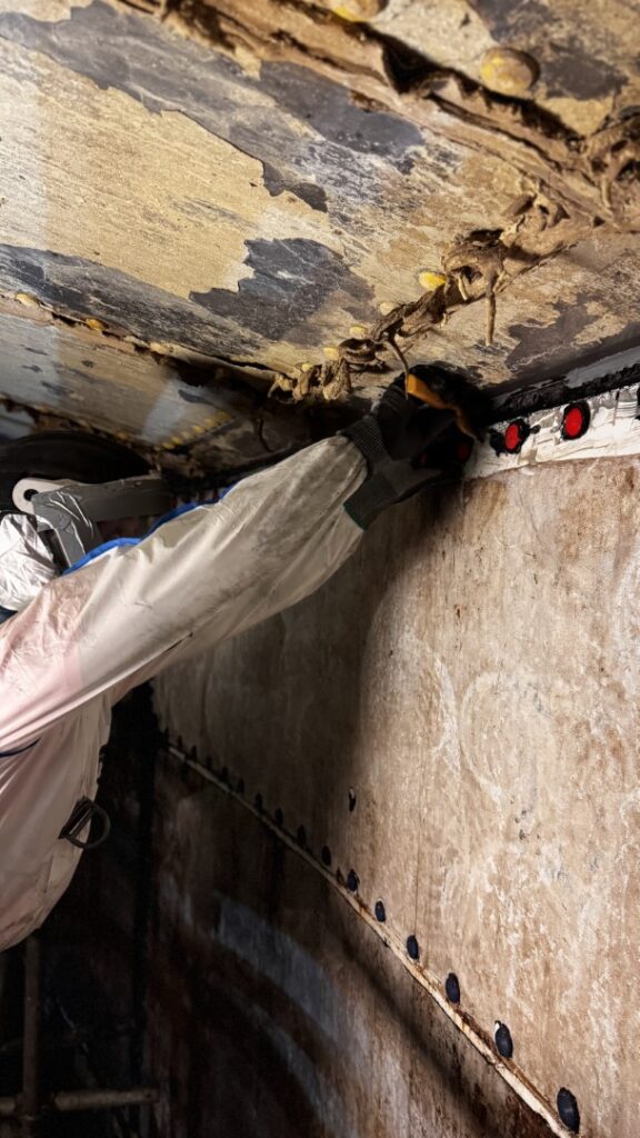 The first step was the removal of the polyurethane pointing applied during original tank construction.