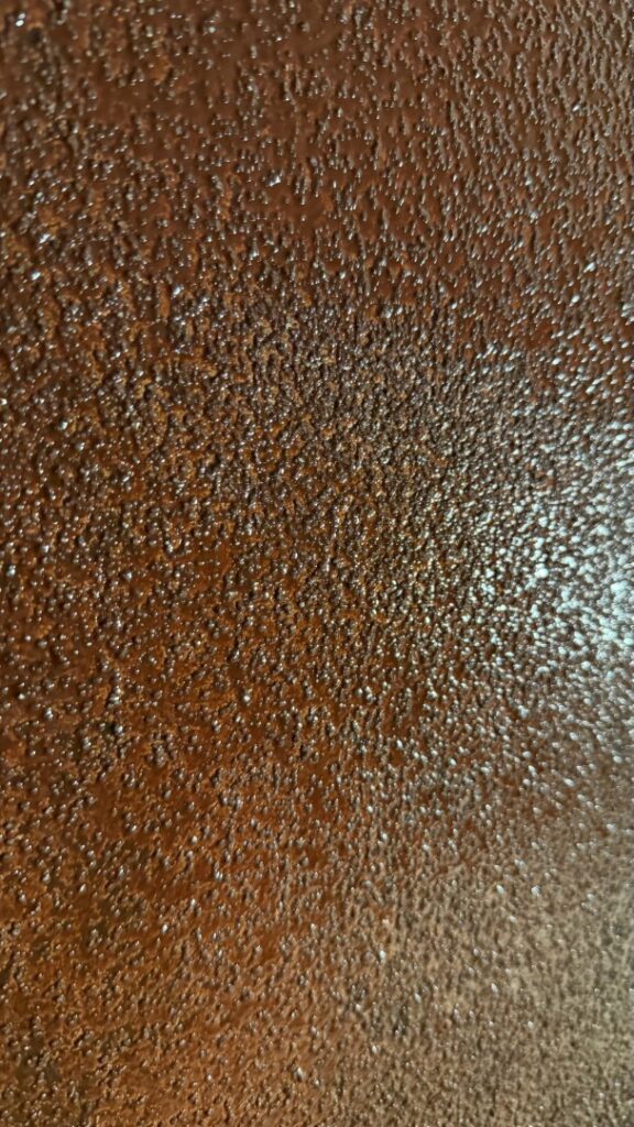 A quartz broadcast mechanical profile was applied into the wet primer to create an optimal bonding surface for the spray-applied polyurea lining.