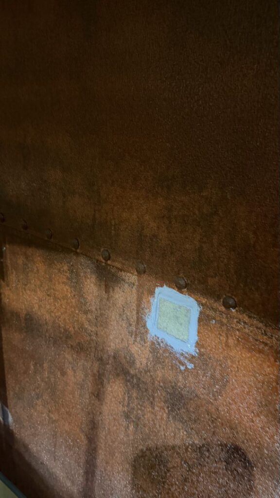 Perforated sections of the tank were bridged using galvanised steel plates bonded with a thixotropic epoxy adhesive