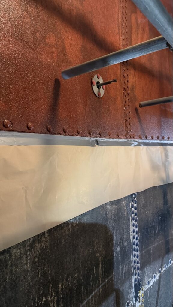 Perforated sections of the tank were bridged using galvanised steel plates bonded with a thixotropic epoxy adhesive