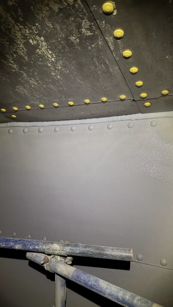 The cured lining was tested using a DC holiday spark tester to identify and address any pinholes, ensuring full continuity of protection — crucial for tank corrosion repair in aggressive wastewater environments.